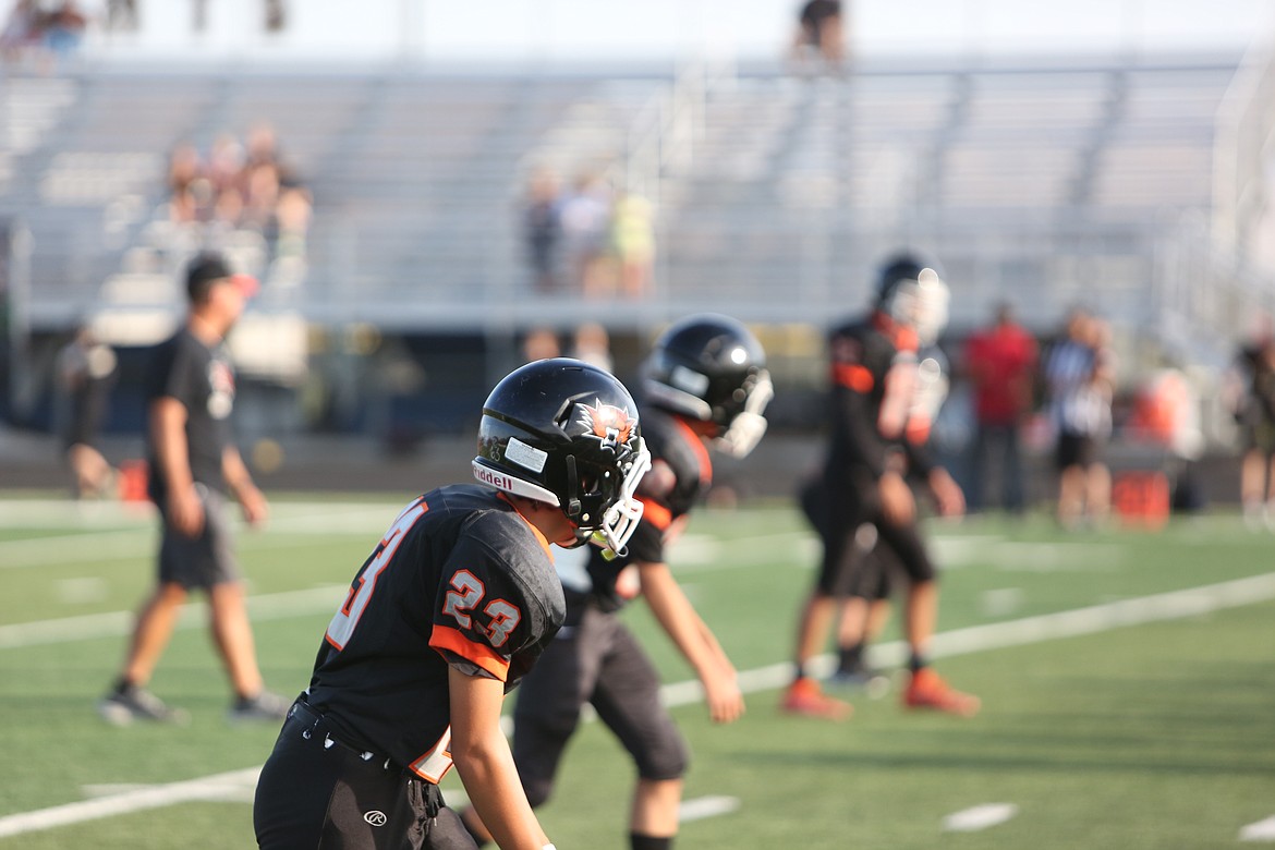 Ephrata receivers look down at the line of scrimmage awaiting the ball to be snapped.