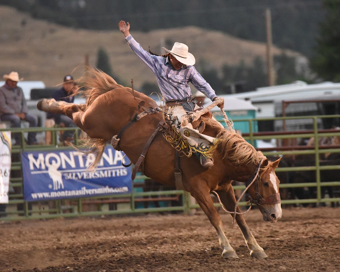 Justin Whiteman shows perfect form in winning the saddle bronc competition. (Marla Hall/Lake County Leader)