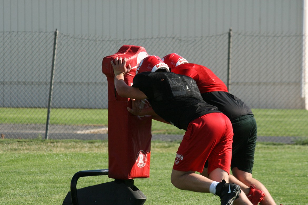 Othello linemen practice their technique on the blocking sled on Aug. 24.