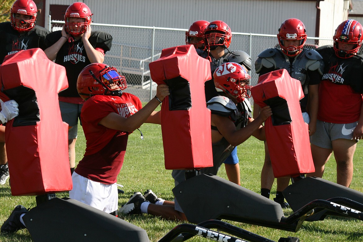 Othello High School linemen put the blocking sleds to use during practice.