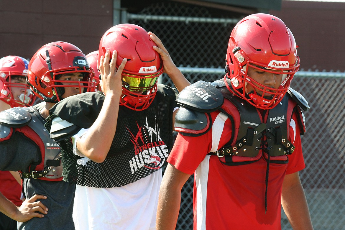 Defensive backs line up to run the obstacle course during Othello High School football practice.