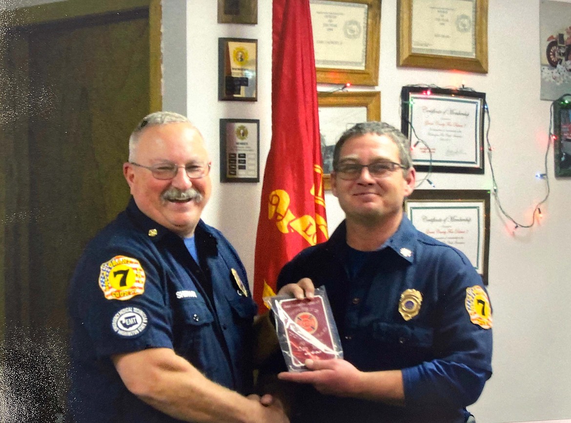 Grant County Fire District 7 Chief Kirk Sheppard smiles as he presents the “Where Was Your Head” award to Dan Burts in 2018.