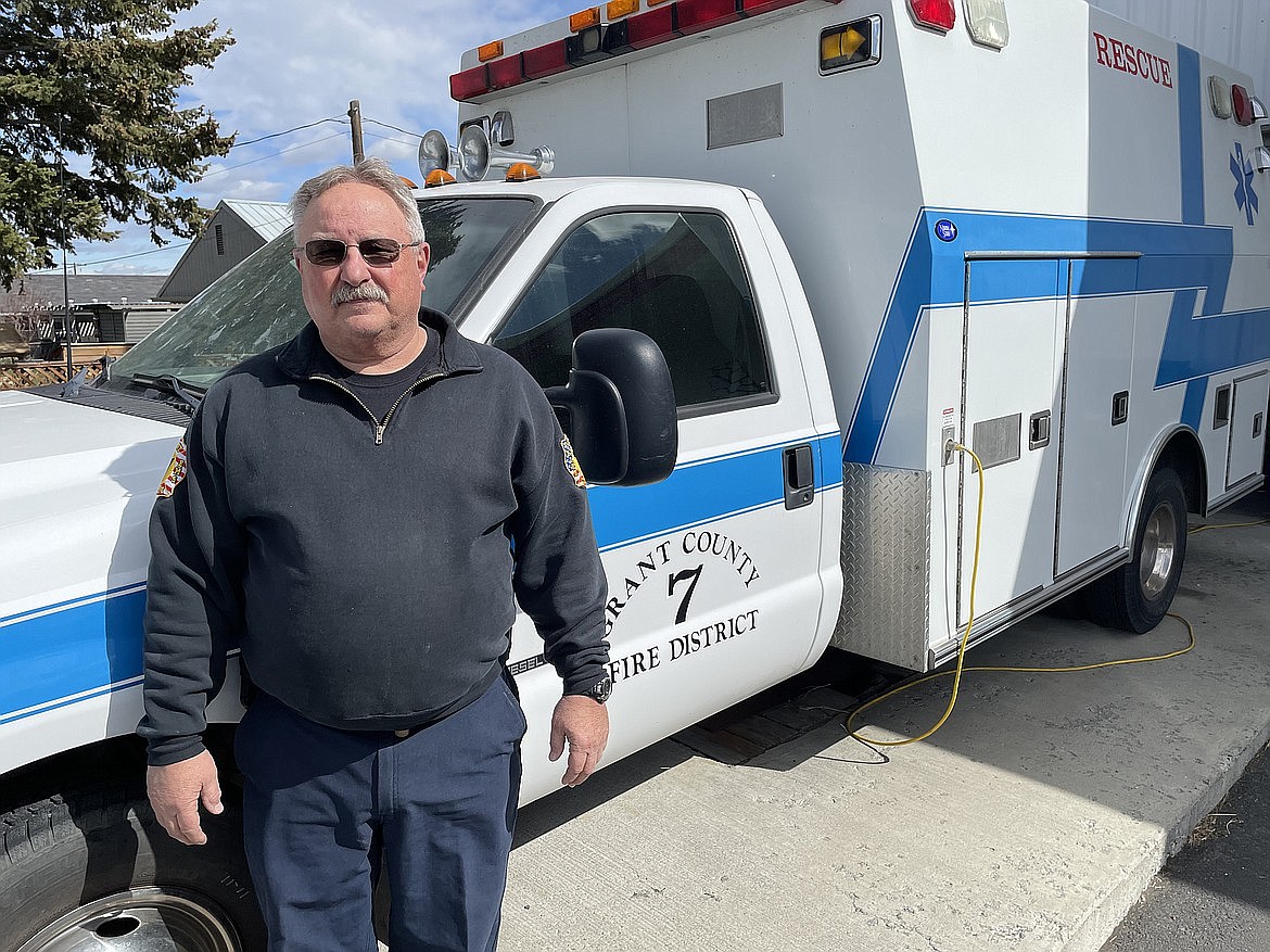 Sheppard poses in front of an ambulance in 2021 when Grant County Fire District 7 was considering implementing an EMS program.