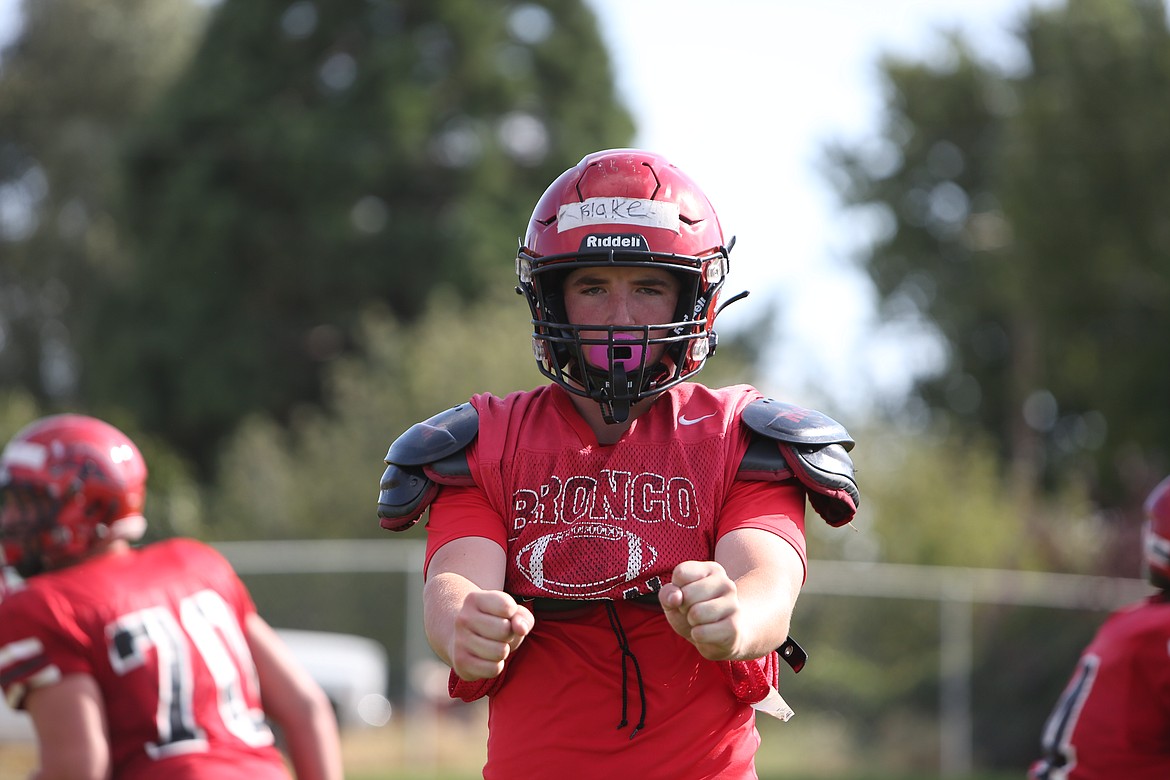 Blake Esser pulls to the left side of the offensive line, holding his arms out during a walk through play.