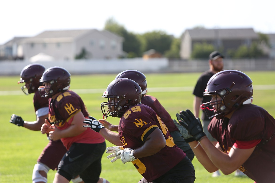 The Moses Lake offensive line works through a drill together. The team’s offensive and defensive lines lost starters due to graduation, head coach Brett Jay said.