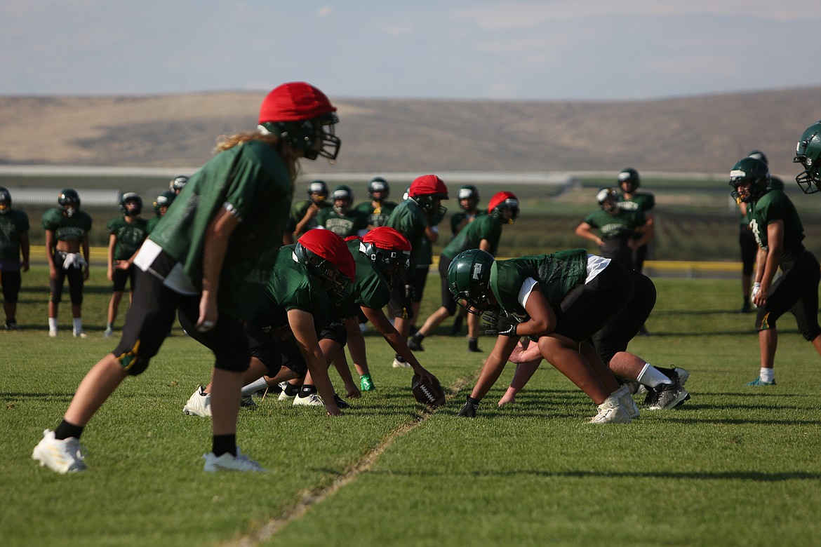 The first team defense lines up against scout team offense during a practice.