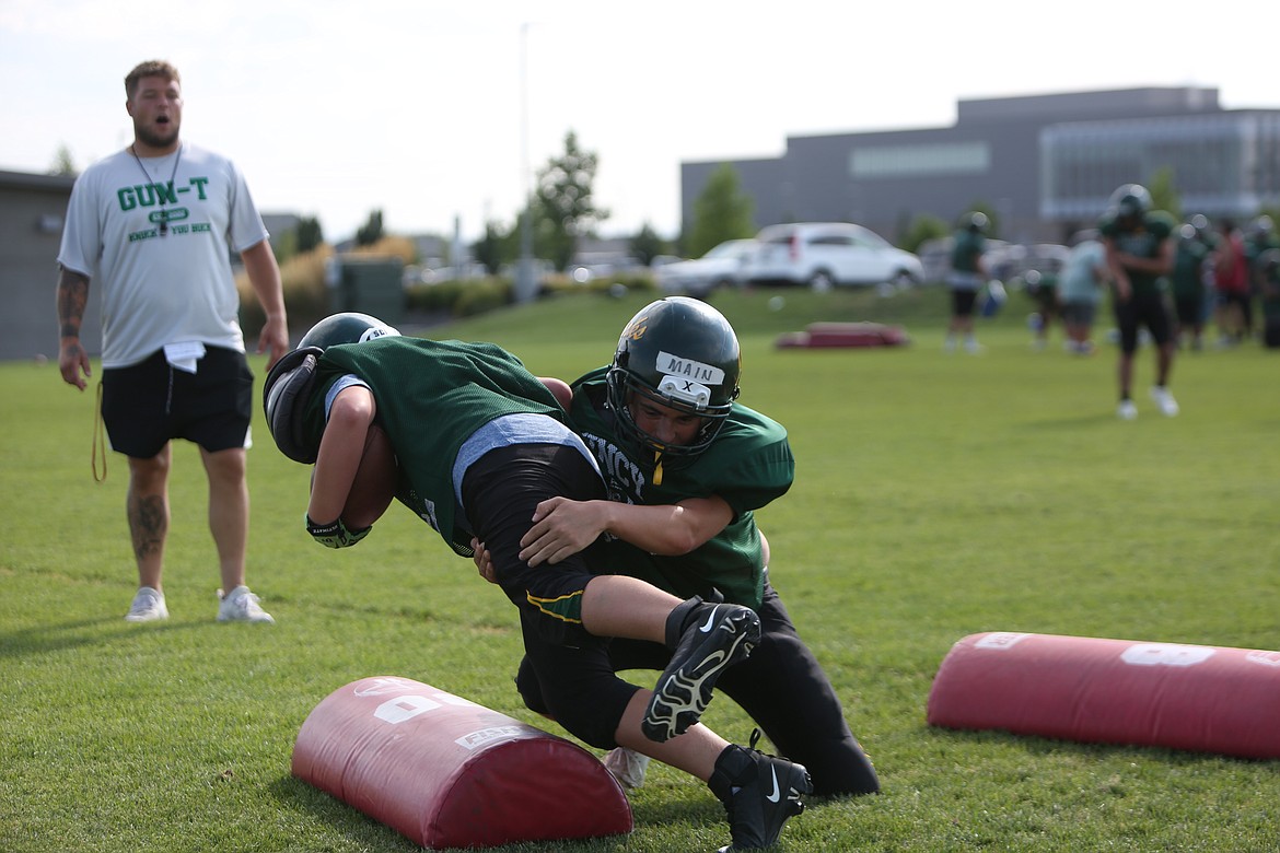 Linebacker Mitchell Main (right) makes a tackle during a drill during practice.