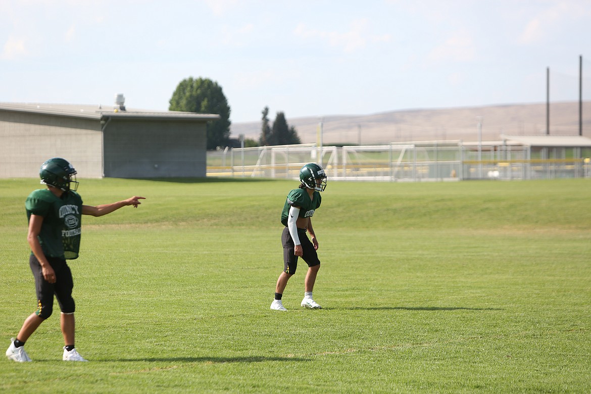 Quincy running back/safety Jackson Yeates waits for the ball to be snapped during a drill.