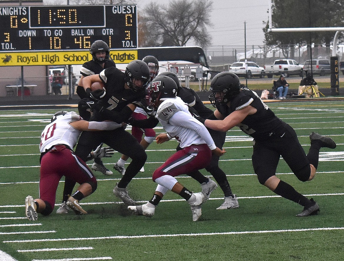 Royal receiver Edgar Delarosa (7) fights off tacklers during Royal's game against Toppenish last season.