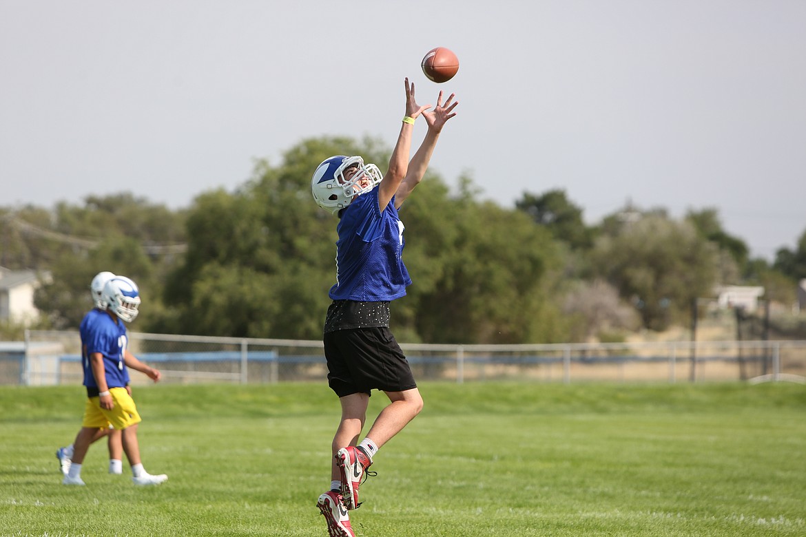 A Soap Lake defensive back leaps up for a catch during drills on August 18.