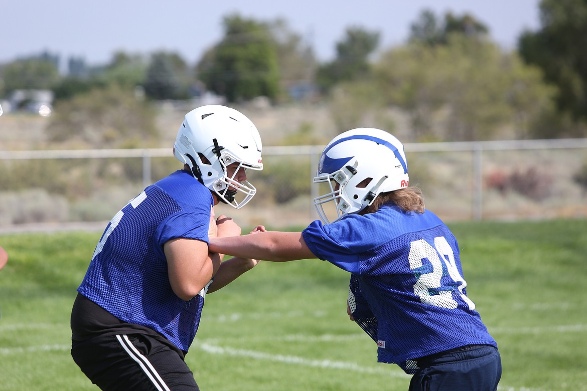 Soap Lake lineman Jesse Morales works through an offensive line drill with another teammate.