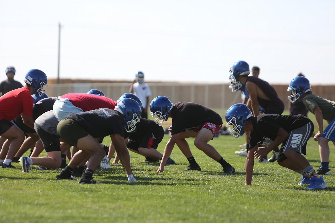 During a walkthrough practice, the Warden football team lines up against each other.