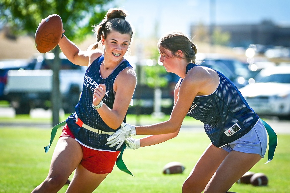 Glacier's Noah Fincher, left, tries to avoid a tackle during flag football practice at Glacier High School on Wednesday, Aug. 31. (Casey Kreider/Daily Inter Lake)