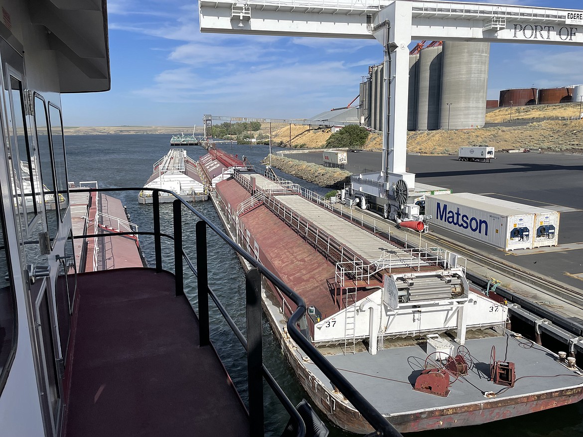 Reassembling the barges of the tow at the Port of Umatilla. A tow is held together by various cables and need to be adjusted occasionally as cables loosen and when barges are added or removed.