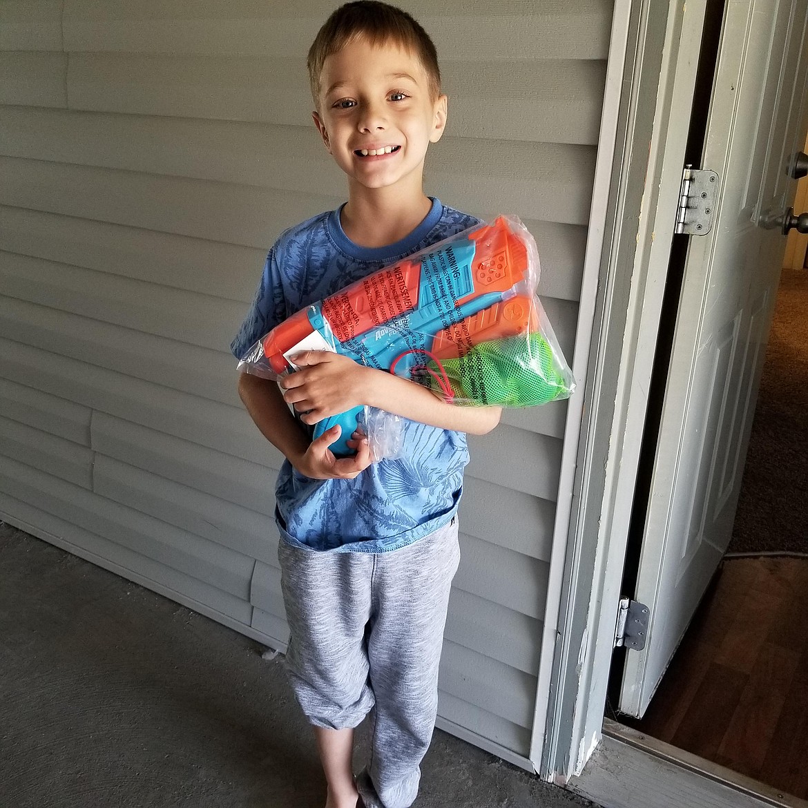 Angelo Adams, who took fifth place in the Grant County Democrats’ Candy Count game, shows off the Super Soaker he won.