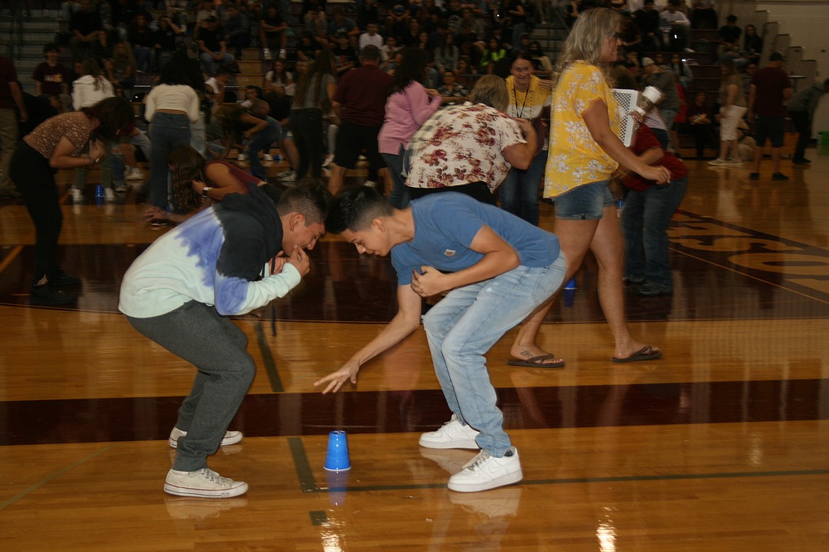 Students make a grab for the cup during a game at Moses Lake High School freshman orientation Wednesday.