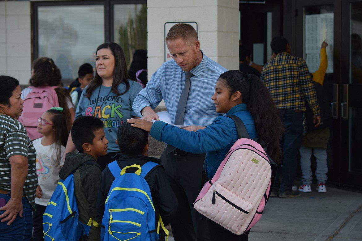 Warden Elementary School Principal Curtis Weber helps students figure out where their classrooms are on the first day of school in the Warden School District on Wednesday.