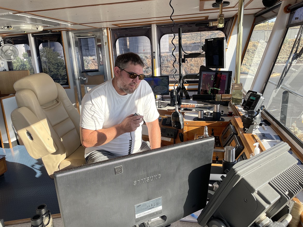 Shaver Transportation senior captain and tugboat pilot Troy Moore in the wheelhouse of the tugboat Lincoln during a voyage down the Snake and Columbia rivers in early August. With 22 years of experience as both a deckhand and a captain, Moore knows his way around the rivers. “This is a nice tow. It’s little,” Moore said of the four barges carrying roughly 13,000 metric tons of wheat he was pushing down the river to Portland.