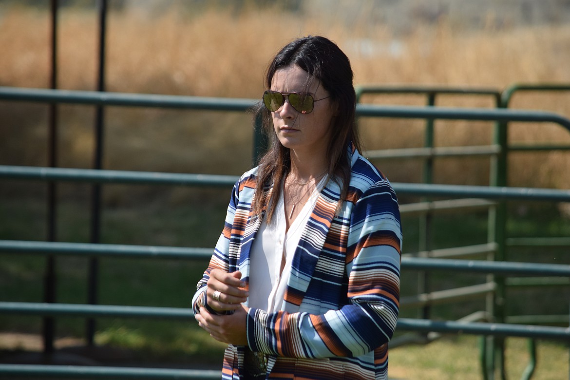 Livestock judge Alexis Andrews looks over the Future Farmers of America market steers during the first day of competition at the Wheat Land Communities’ Fair in Ritzville on Thursday.