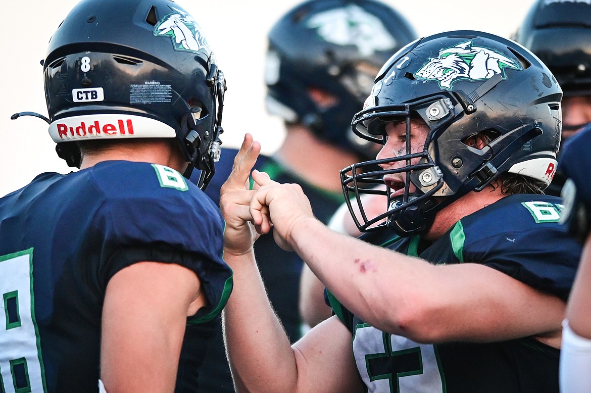 Glacier offensive lineman TJ Gannon (62) counts to four on his fingers after wide receiver Evan Barnes' (8) fourth touchdown reception against Great Falls CMR at Legends Stadium on Friday, Sept. 2. (Casey Kreider/Daily Inter Lake)