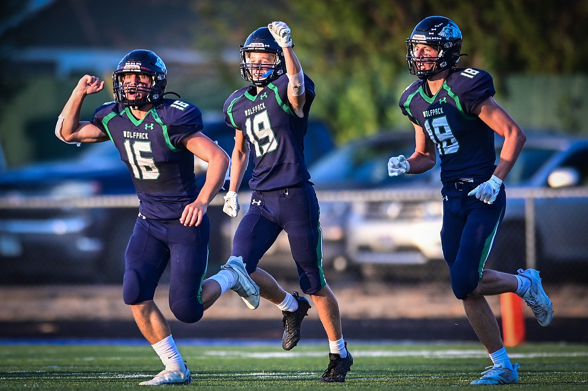 Glacier defenders Kaleb Shine (16), Easton Kauffman (19) and Cameron Shaw (18) head off the field after Shine recovered a fumble against Great Falls CMR at Legends Stadium on Friday, Sept. 2. (Casey Kreider/Daily Inter Lake)
