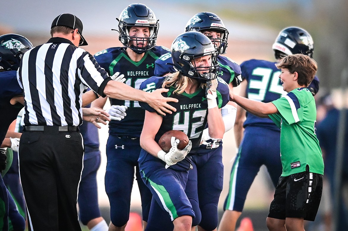 Glacier's Dylan Whitten (42) celebrates with teammates after recovering an onside kick against Great Falls CMR at Legends Stadium on Friday, Sept. 2. (Casey Kreider/Daily Inter Lake)