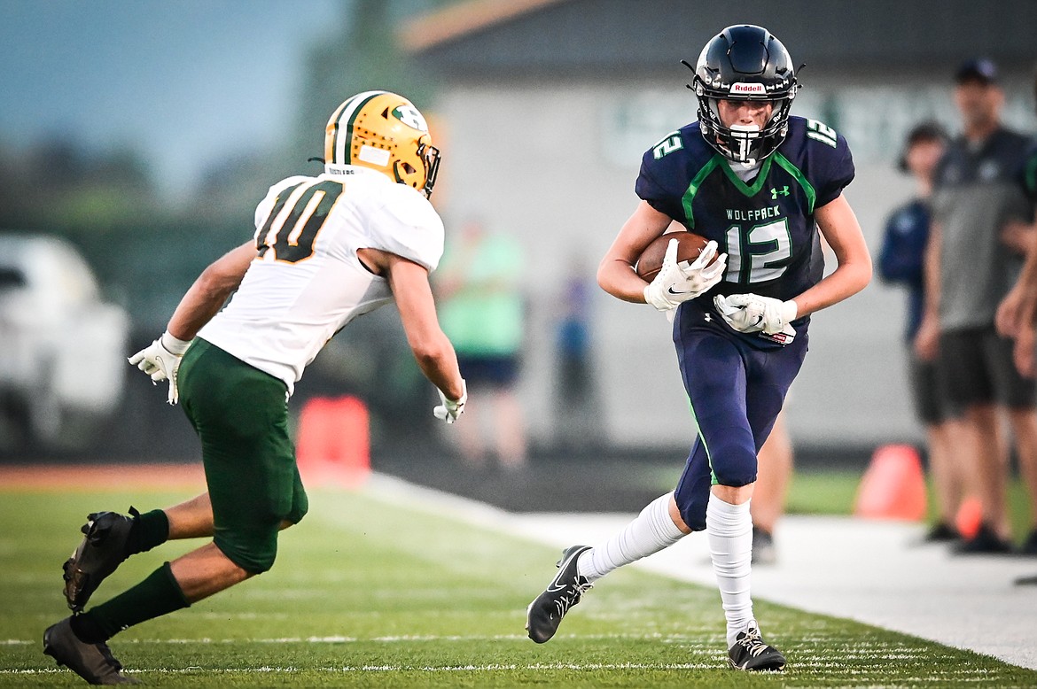 Glacier wide receiver Bridger Smith (12) picks up yardage after a catch against Great Falls CMR at Legends Stadium on Friday, Sept. 2. (Casey Kreider/Daily Inter Lake)
