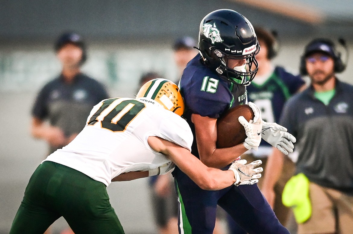 Glacier wide receiver Bridger Smith (12) picks up yardage after a catch against Great Falls CMR at Legends Stadium on Friday, Sept. 2. (Casey Kreider/Daily Inter Lake)