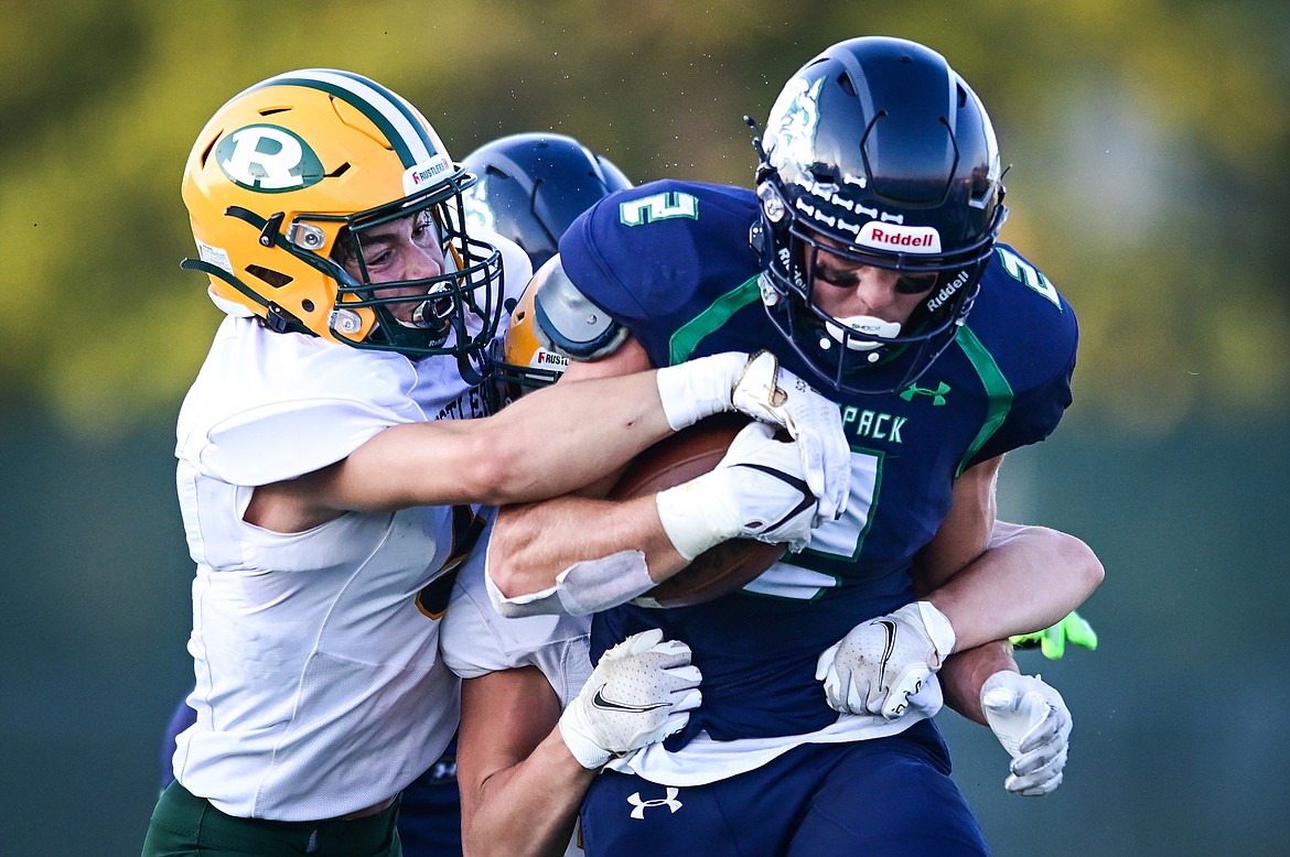 Glacier running back Jackson Hensley (2) is brought down by Great Falls CMR's River Wasson (5) at Legends Stadium on Friday, Sept. 2. (Casey Kreider/Daily Inter Lake)