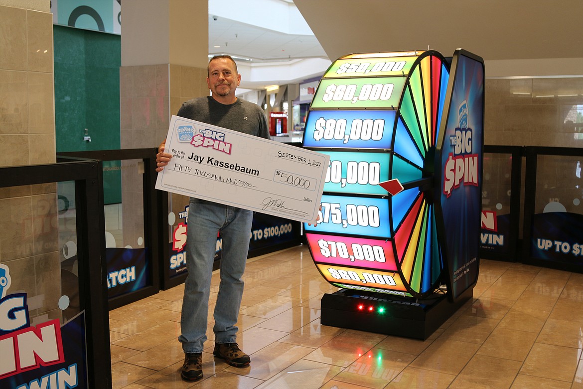 Jay Kassebaum holds a check for $50,000 after taking part in the Idaho Lottery's second Big Spin event on Thursday.