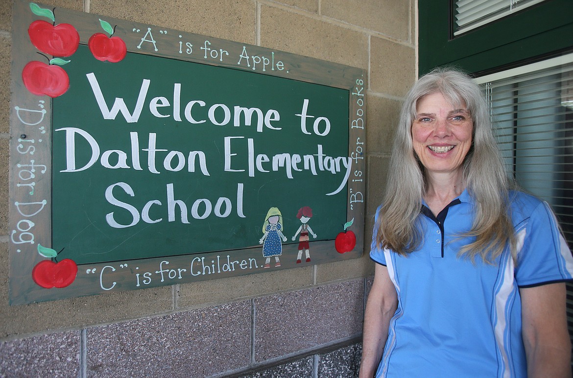 Nancy Nuttelman on Friday stands near the entrance of Dalton Elementary School, where she taught first grade for 31 years. She retired this summer after 40 years with the Coeur d'Alene School District.