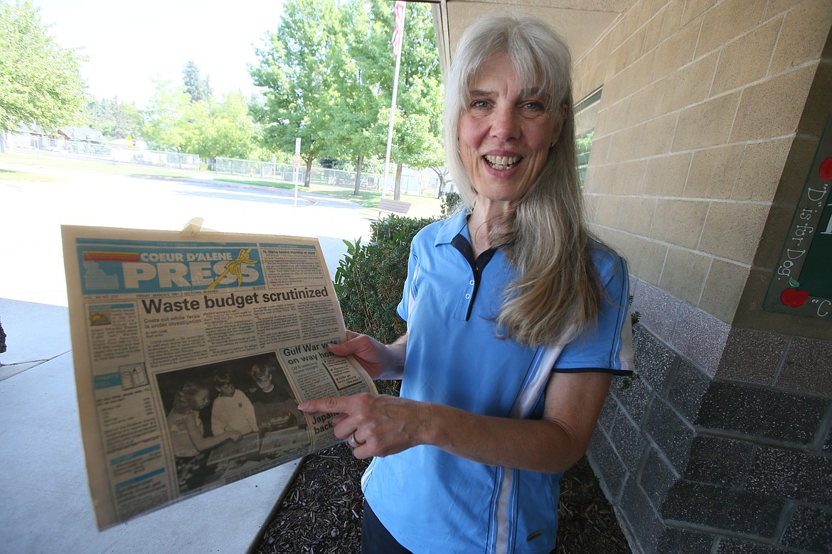 Newly retired Nancy Nuttelman points to a March 8, 1991 Coeur d'Alene Press featuring her students working on magnetic boards thanks to funds she acquired after being awarded an Excel Foundation grant for her classroom.