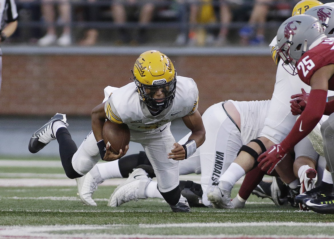 YOUNG KWAK/Associated Press
Idaho quarterback Gevani McCoy dives for a first down as Washington State defensive back Jaden Hicks, right, closes in during the first half of Saturday’s game in Pullman.