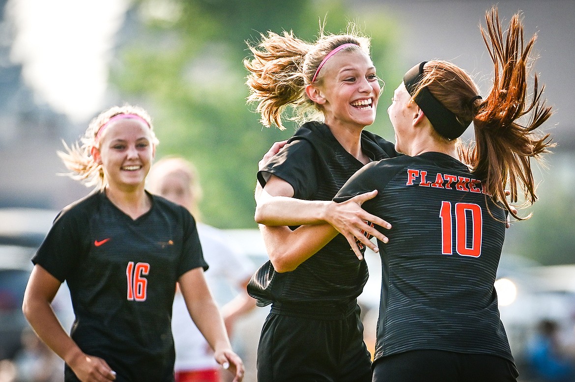 Flathead's Mia Stephan (11), center, celebrates with Ally Pollan (10) and Kyrie Gislason (16) after her goal in the first half against Missoula Hellgate at Kidsports Complex on Saturday, Sept. 3. (Casey Kreider/Daily Inter Lake)