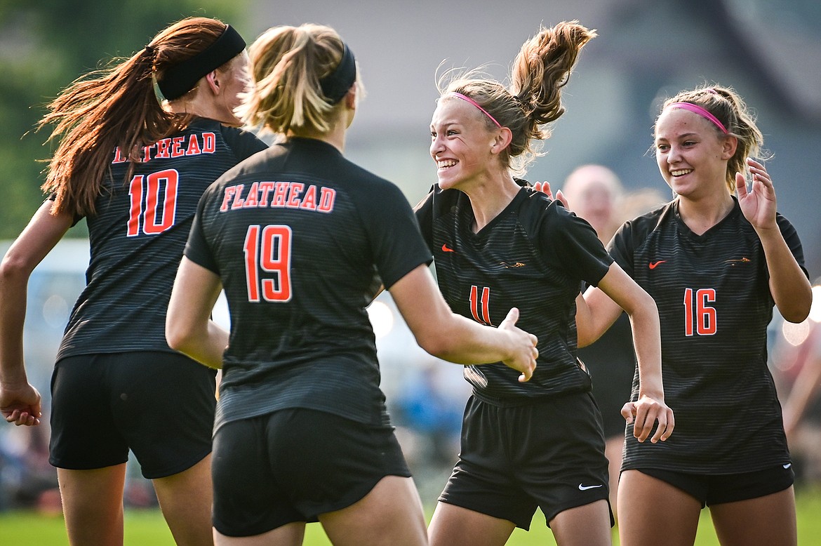 Flathead's Mia Stephan (11) celebrates with Ally Pollan (10), Alivia Rhinehart (19) and Kyrie Gislason (16) after her goal in the first half against Missoula Hellgate at Kidsports Complex on Saturday, Sept. 3. (Casey Kreider/Daily Inter Lake)