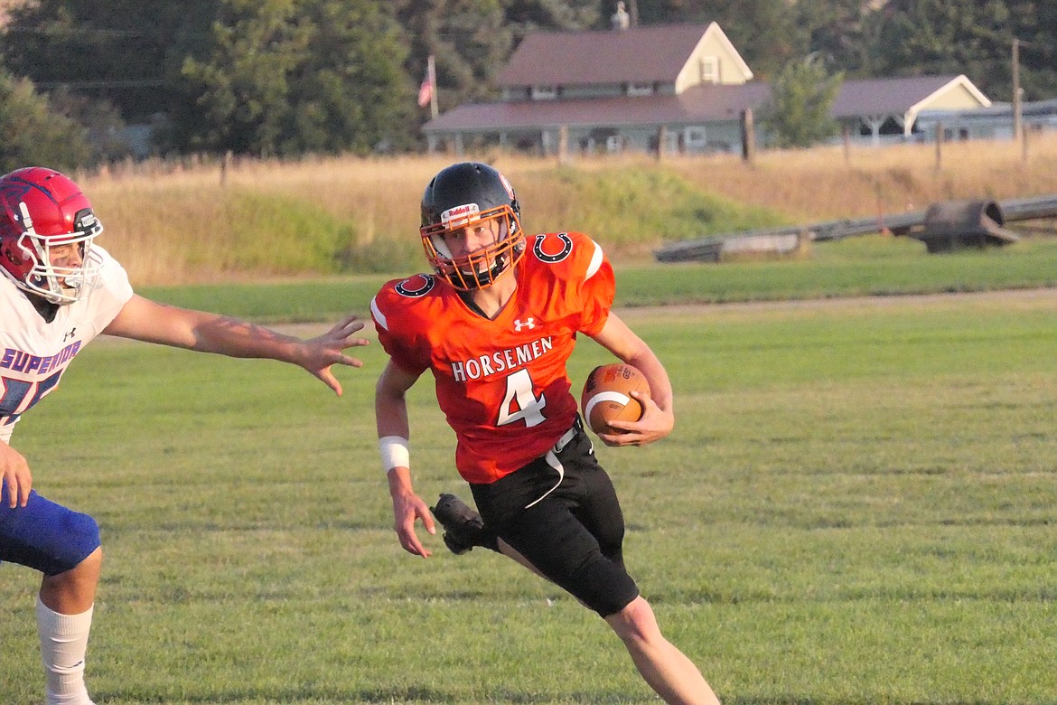 Plains quarterback Mason Elliot runs by Superior defender Jaxson Green during the Bobcats' win over the Horsemen Thursday night in Plains.  (Chuck Bandel/VP-MI)