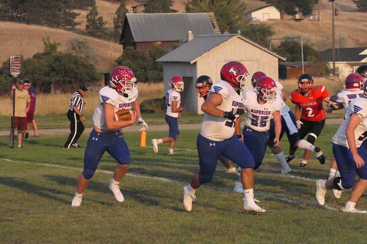 Superior quarterback Orion Plakke, with ball, follows the blocking of lineman Chandon Vulles as he runs for a big gain during the Bobcats' game against Plains at Plains High Thursday evening.  (Chuck Bandel/VP-MI)