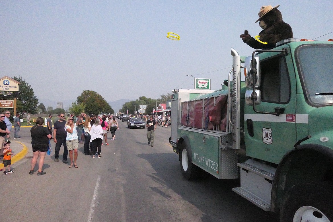 Smokey T. Bear tosses rings to the crowd, which lined both sides of the street for several blocks. (Chuck Bandel/Valley Press)