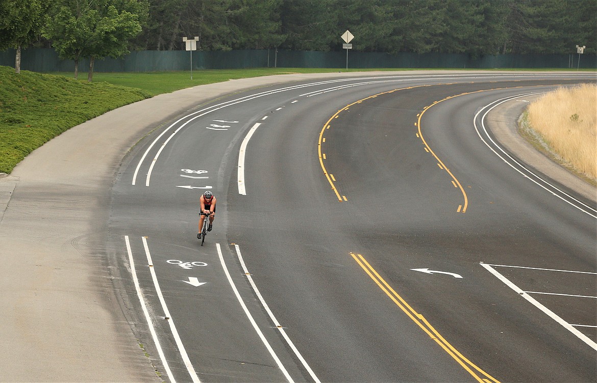 A cyclist rides in the designated bike lane on Coeur d'Alene Lake Drive on Saturday.