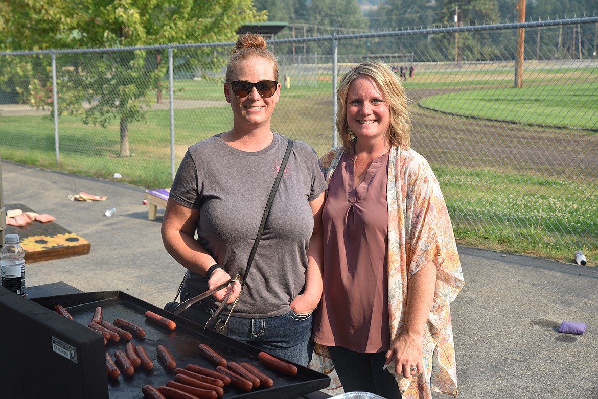 Jamie Shupe and Josie Hermes were in charge of grilling hot dogs during tailgating before the Troy home football game on Friday, Sept. 2. (Scott Shindledecker/The Western News)