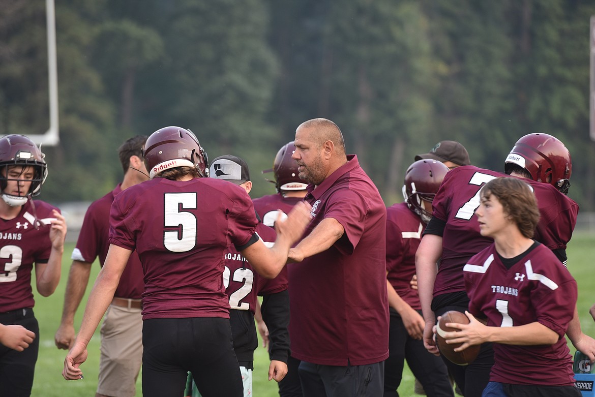 The Troy Trojans, including assistant coach Scott Hoffman, celebrate a touchdown against the Mission Bulldogs Friday, Sept. 2. (Scott Shindledecker/The Western News)