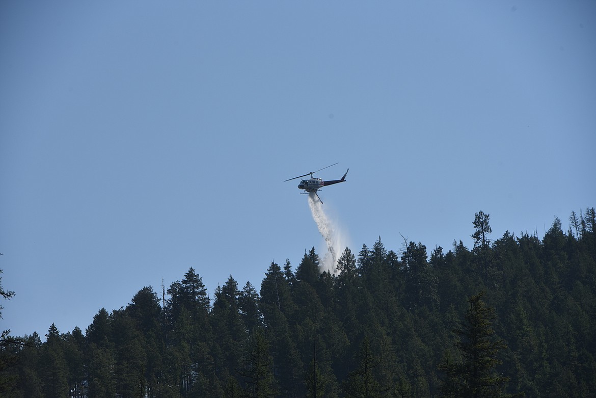 A helicopter drops water on the Williams Creek Fire on Thursday, Sept. 1. (Scott Shindledecker/The Western News)