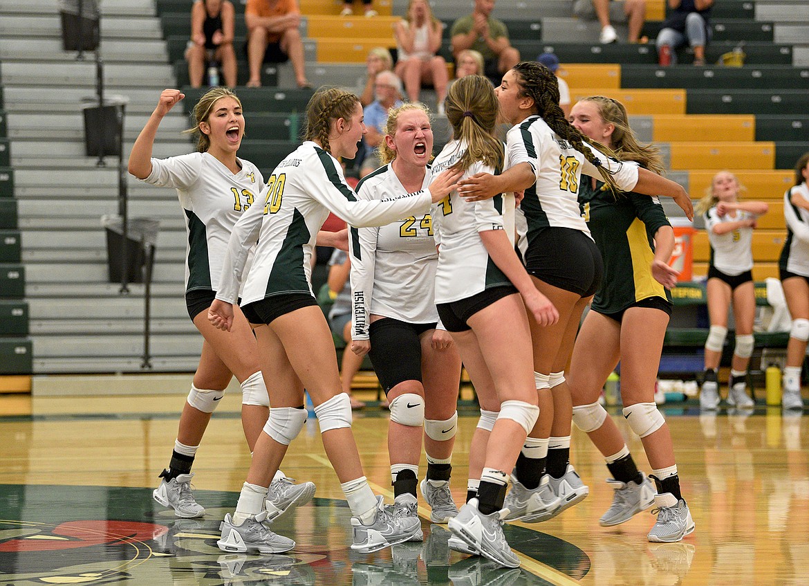 The Whitefish volleyball team celebrates winning a point against Stillwater on Thursday at Whitefish High School. (Whitney England/Whitefish Pilot)