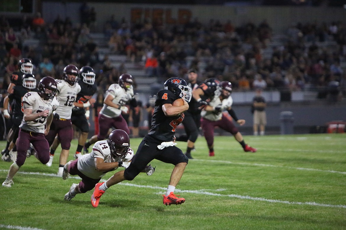 Ephrata quarterback Travis Hendrick runs the ball upfield on a quarterback power run.