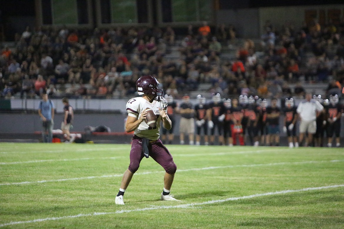 Maverick quarterback Brock Clark drops back to pass in the fourth quarter of Moses Lake’s season opener.