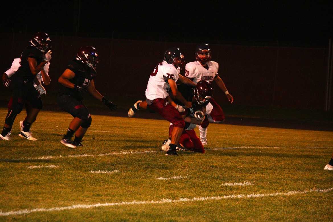 Running back Anthony Zebrano fights for yardage against the Grandview defenders in Friday’s football season opener.