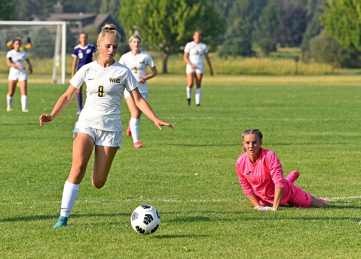 Lady Bulldog Delaney Smith gets around Livingston goalkeeper Paige Whalin to score in the first half of a game at Smith Fields on Friday. (Whitney England/Whitefish Pilot)