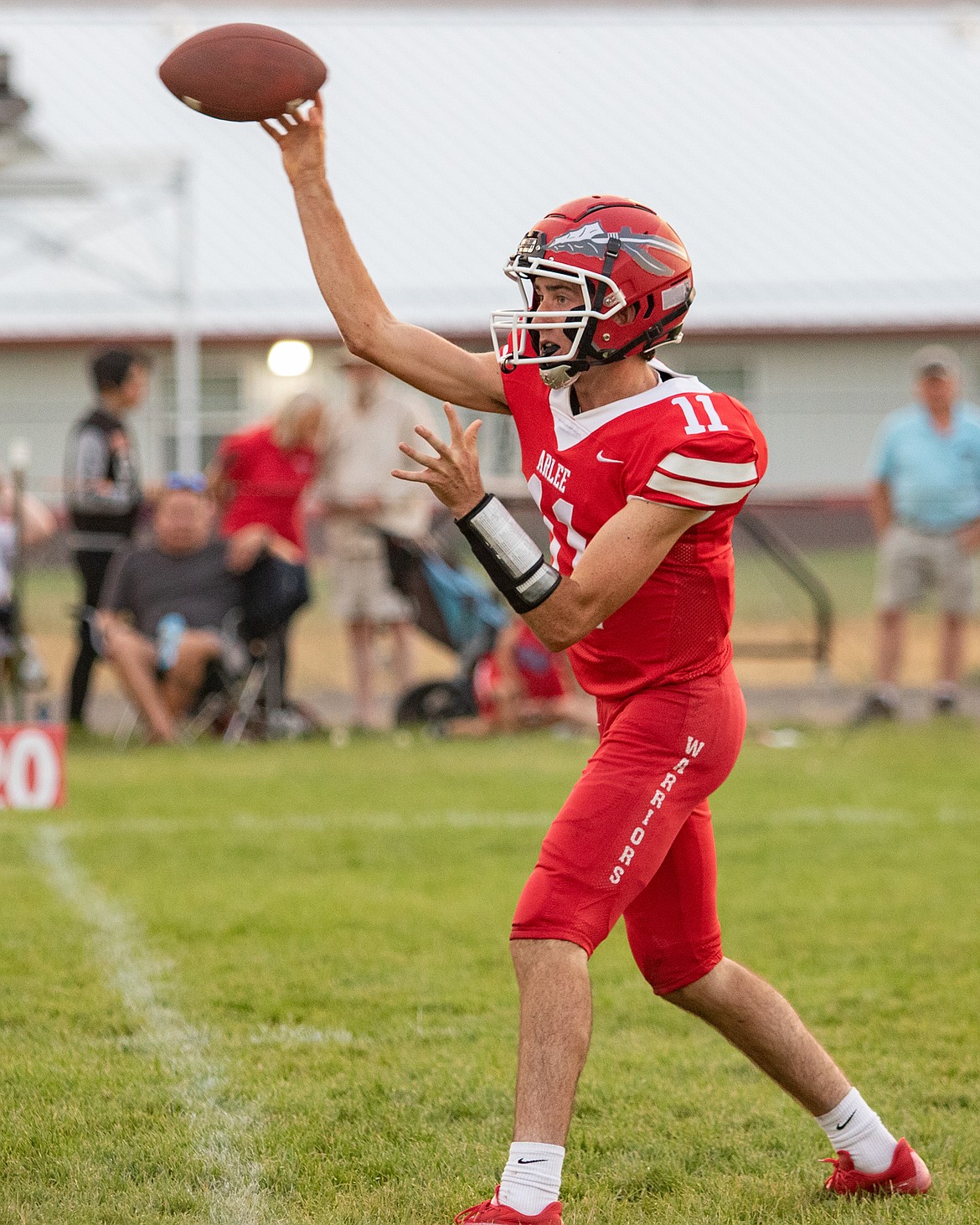 Arlee Warrior quarterback Kendall O'Neill completes a pass to an open receiver during the second quarter of Friday evening’s home game against the Charlo Vikings. (Rob Zolman/Lake County Leader)