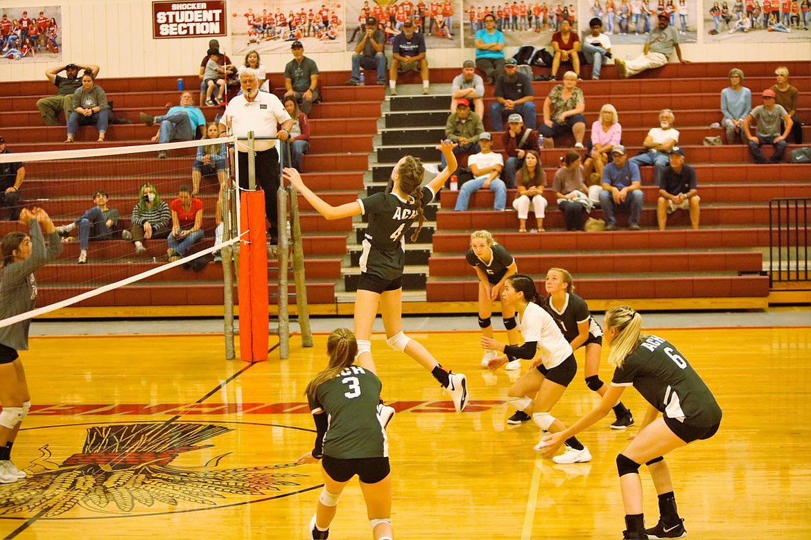 Junior Natalie Evers leaps to spike the ball during a match Tuesday evening.