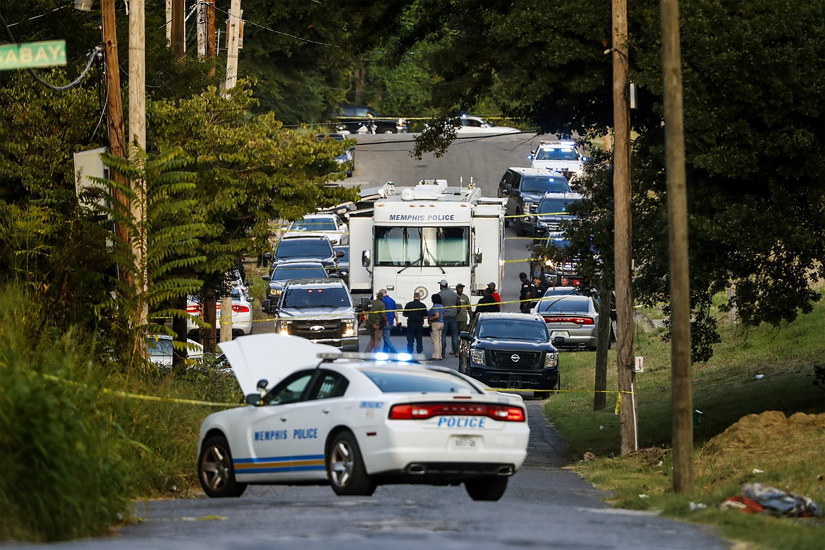 Memphis police officers search an area where a body had been found in South Memphis, Tenn., near Victor Street and East Person Ave., Monday, Sept. 5, 2022. Police have not confirmed the identity of the body and the cause of death was unconfirmed. (Mark Weber/Daily Memphian via AP)